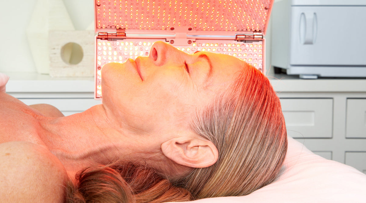 Close up profile of older woman recieving an LED device treatment