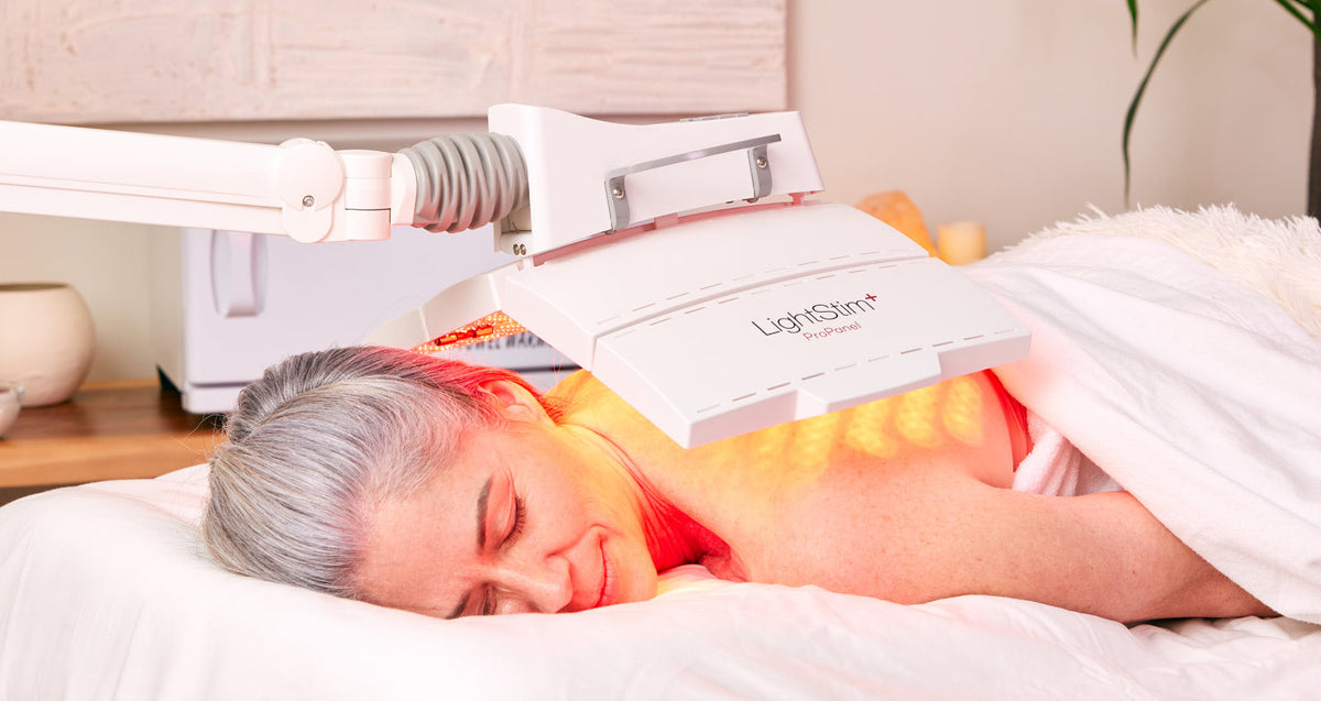 Image of woman using LightStim ProPanel on her back