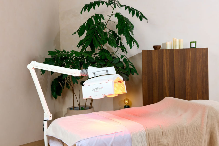 A LightStim ProPanel on its stand beside a treatment bed